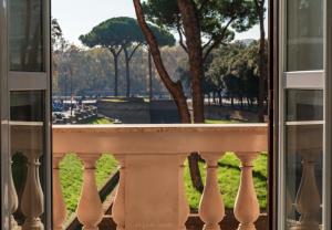 a balcony with a view of a park through a window at WE LOVE ROMA Guest House in Rome