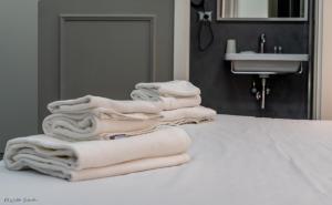 a pile of towels sitting on a counter in a bathroom at WE LOVE ROMA Guest House in Rome
