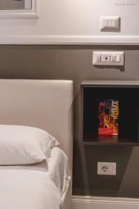 a bedroom with a bed and a tv on a wall at WE LOVE ROMA Guest House in Rome
