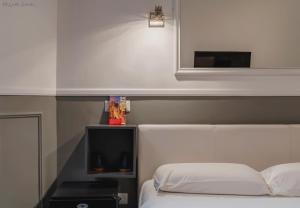 a bedroom with a white bed and a tv at WE LOVE ROMA Guest House in Rome