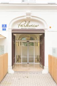 an entrance to a building with a sign that reads alhamine furniture at Parkview Boutique Apartments in Vienna