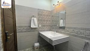 a bathroom with a sink and a mirror at Multazam Heights, DHA Phase 8 - 3 Bedrooms Luxury Apartments in Lahore +19 photos
