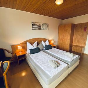 a bedroom with a large bed with white sheets and pillows at Haus Löhrberg in Hemer