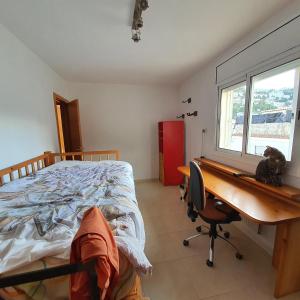 a bedroom with a bed and a desk with a cat on it at Hilda's Room in Roses