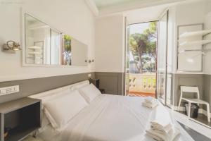 a bedroom with a white bed and a large window at WE LOVE ROMA Guest House in Rome
