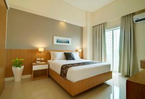 Postel nebo postele na pokoji v ubytování Zerenity Hotel & Suites