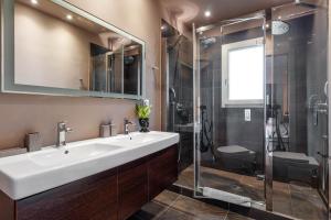a bathroom with a sink and a shower at Luxury Villa Helanes in Corfu Town