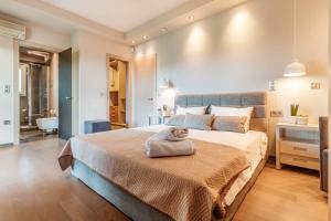 a bedroom with a large bed and a bathroom at Luxury Villa Helanes in Corfu Town