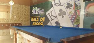 a pool table in a room with a wall at Hotel Aracaju Express in Aracaju
