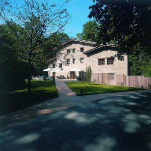 a large white house with a fence in front of it at Hotel Can Blanc in Olot