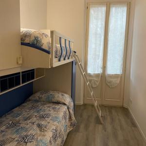 a bedroom with a bunk bed and a bunk ladder at Un balcone sul centro storico in Reggio Emilia