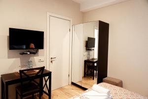 a room with a bedroom with a bed and a mirror at Hotel Winoterra in Tbilisi City