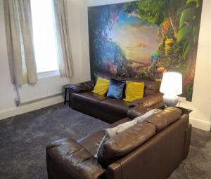 a living room with two couches and a painting at Modern comfy 2-Bedroom flat in St Helens in Saint Helens