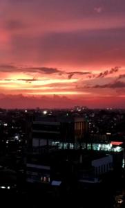 a view of a city at sunset at Apartement Grand Asia Afrika Bandung by House Of Tofi in Bandung