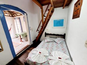 a bedroom with a bed with two pillows on it at Pousada Recanto dos Nativo in Paraty