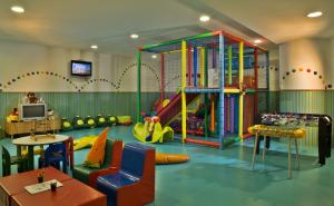 a childrens play room with a slide and a play area at Hotel Cascais Miragem Health & Spa in Cascais