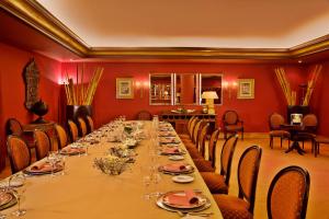 a long table in a room with red walls at Hotel Cascais Miragem Health & Spa in Cascais