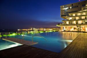 a pool on the roof of a building at night at Hotel Cascais Miragem Health & Spa in Cascais