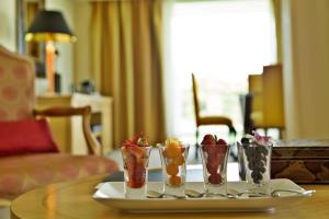 a table with four vases with fruit in them at Hotel Cascais Miragem Health & Spa in Cascais