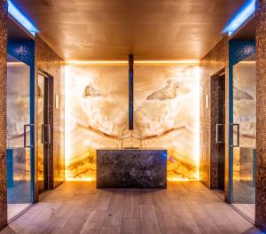 a bathroom with a bathtub in front of a wall at Hotel Cascais Miragem Health & Spa in Cascais