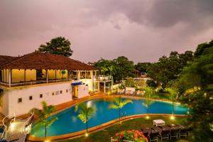 an image of a swimming pool at night at Moustache Goa Luxuria in Vagator