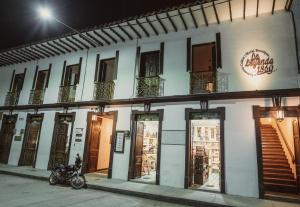 a building with a motorcycle parked in front of it at Hotel Boutique La Leyenda 1860 in Salamina