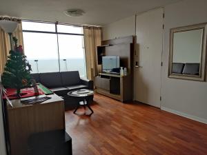 a living room with a couch and a table at Blue Coast Lima private rooms Peru in Lima