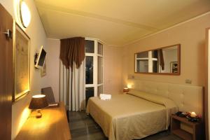 Postel nebo postele na pokoji v ubytování Hotel Antica Tabaccaia Resort