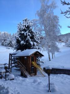 a playground in the snow with a slide at Hotel Restaurant Bürchnerhof in Bürchen