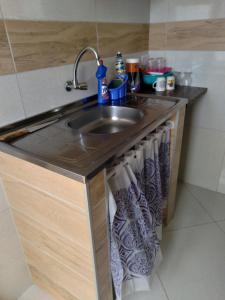 a kitchen counter with a sink and towels at Kitnet 2,vista fantastica in Cabo de Santo Agostinho