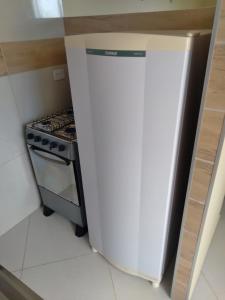 a white refrigerator in a kitchen next to a stove at Kitnet 2,vista fantastica in Cabo de Santo Agostinho