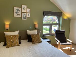 Un pat sau paturi într-o cameră la Hotel Bibois