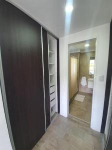 a room with a closet with a door and a bathroom at Departamento con vista al río in Victoria +14 photos