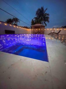 a swimming pool with purple lighting on a house at MIAMI PARADISE in Miami