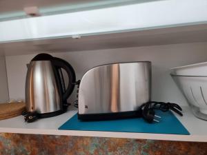 a silver and black toaster sitting on a shelf at Lifestyle-Appartment near BASF in Ludwigshafen in Ludwigshafen am Rhein