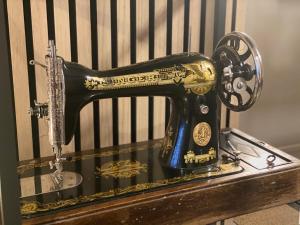 a black and gold sewing machine sitting on a table at Cosy Harbour Apartment in Reykjavík