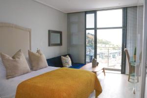 a bedroom with a bed and a large window at 2218 at 16 on Bree in Cape Town