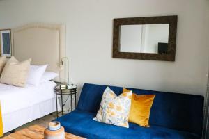a living room with a blue couch and a mirror at 2218 at 16 on Bree in Cape Town +8 photos