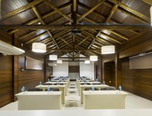 a conference room with white tables and chairs at Bormon Hotel in Nova Veneza +49 photos