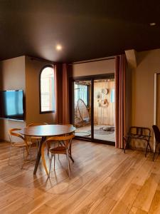 a dining room with a table and a tv at Palm Beach in Ajaccio