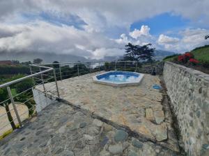 a hot tub sitting on top of a stone wall at Finca Prometeo - Lago Calima in Calimita