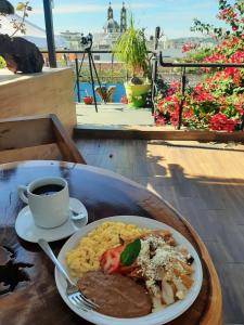 a plate of food on a table with a cup of coffee at Hotel Boutique Casa Mariano in Tepic