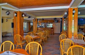 a restaurant with tables and chairs and a bar at Mountain Breeze in Predeal