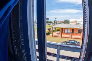 a view from a train window of a building at Hotel Recanto do Mar in Capão da Canoa