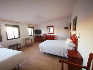 A bed or beds in a room at La Quinta De Santillan