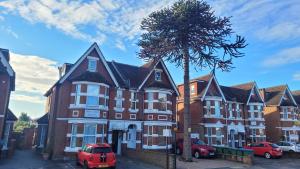 a large building with cars parked in front of it at Argyle Lodge in Southampton