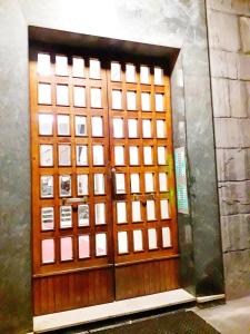 a wooden door with a bunch of squares on it at Old Center Station in Bologna