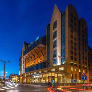a building on a city street at night at Radisson Blu Hotel, Antwerp City Centre in Antwerp