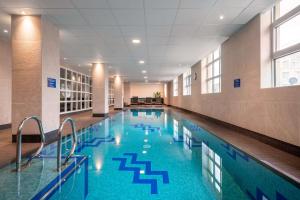 a large swimming pool in a large building at Radisson Blu Hotel, Antwerp City Centre in Antwerp