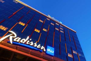 a tall blue building with a sign on it at Radisson Blu Chelyabinsk Hotel in Chelyabinsk